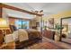 Spacious main bedroom with a wooden bed frame, ensuite bath, and outdoor view through the window at 5625 Escondida S Blvd, St Petersburg, FL 33715