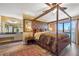 Serene main bedroom featuring a four-poster bed, ensuite bath, and scenic outdoor views at 5625 Escondida S Blvd, St Petersburg, FL 33715