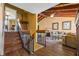 Staircase leading to a bright living area with vaulted wood ceilings and views to the outside at 5625 Escondida S Blvd, St Petersburg, FL 33715