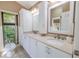 Elegant bathroom with dual sinks, ample cabinet space, and natural light from a large window at 5953 36Th N Ave, St Petersburg, FL 33710
