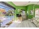 Green bedroom with sliding glass doors to the pool and a four-poster bed at 5953 36Th N Ave, St Petersburg, FL 33710