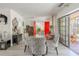 Bright dining room featuring a glass table, four zebra-striped chairs, and red doors at 5953 36Th N Ave, St Petersburg, FL 33710
