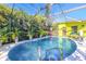 Inviting screened-in pool surrounded by lush landscaping and a colorful exterior at 5953 36Th N Ave, St Petersburg, FL 33710