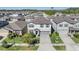 Aerial view of a light-colored two-story home with a landscaped front yard and a two-car garage at 6236 Dutton Dr, Wesley Chapel, FL 33545