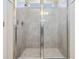 Tiled shower with a glass door and window, adding natural light to the space at 6236 Dutton Dr, Wesley Chapel, FL 33545