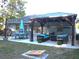 Inviting backyard with patio, gazebo, outdoor seating, well-manicured lawn, and string lights at 6701 Medlar Dr, New Port Richey, FL 34653