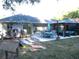 Spacious backyard with patio, gazebo, outdoor seating, lush greenery, and charming string lights at 6701 Medlar Dr, New Port Richey, FL 34653
