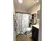 Small bathroom with anchor-themed decor, a vanity with a dark cabinet, and a shower at 6701 Medlar Dr, New Port Richey, FL 34653
