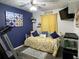 Cozy bedroom featuring a daybed, yellow accents, a dark blue accent wall, and a ceiling fan at 6701 Medlar Dr, New Port Richey, FL 34653