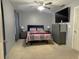 Cozy bedroom with a full-sized bed, gray walls, and minimalist decor at 6701 Medlar Dr, New Port Richey, FL 34653