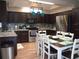 Modern kitchen with stainless steel appliances, granite countertops, and a dining table at 6701 Medlar Dr, New Port Richey, FL 34653