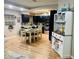 Open kitchen and dining area with dark cabinets, stainless steel appliances, and a large dining table at 6701 Medlar Dr, New Port Richey, FL 34653