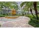 A beautifully landscaped garden features a fountain, lush plants and a mosaic tiled pathway at 700 S Harbour Island Blvd # 240, Tampa, FL 33602
