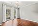 Bright living room featuring a modern chandelier, hardwood floors, and large windows with balcony access at 700 S Harbour Island Blvd # 240, Tampa, FL 33602