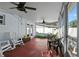 Screened patio featuring fans, furniture, and an outside view at 724 38Th Ne Ave, St Petersburg, FL 33704