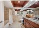 Bathroom with shower and tub combo, granite countertops, hardwood cabinets, and travertine tile at 8032 13Th S Ave, St Petersburg, FL 33707