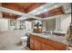Bathroom with hardwood cabinets, granite countertops, tile walls, and unique ceiling at 8032 13Th S Ave, St Petersburg, FL 33707