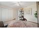 Bedroom featuring closet, ceiling fan, wardrobe with wooden doors, and a large decorative rug at 8032 13Th S Ave, St Petersburg, FL 33707