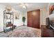 Bedroom featuring hardwood floors, ceiling fan, and wardrobe with wooden doors at 8032 13Th S Ave, St Petersburg, FL 33707