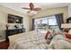 Bright bedroom with a scenic waterfront view, complemented by a decorative ceiling fan and plush bedding at 8032 13Th S Ave, St Petersburg, FL 33707