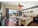 Elegant bedroom with a view of the water, featuring a unique ceiling fan and comfortable furnishings at 8032 13Th S Ave, St Petersburg, FL 33707