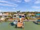 A luxurious waterfront home features a private dock, pool, and covered seating, all amid lush landscaping at 8032 13Th S Ave, St Petersburg, FL 33707