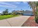 Features a long driveway, a two-car garage, and a well-manicured lawn, showcasing its curb appeal at 8032 13Th S Ave, St Petersburg, FL 33707