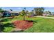 Expansive front yard with lush green lawn and well-maintained landscape beds, showcasing the property's curb appeal at 8032 13Th S Ave, St Petersburg, FL 33707