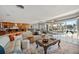 Airy living room boasts tile floors, a sectional sofa, and stunning backyard views at 8032 13Th S Ave, St Petersburg, FL 33707