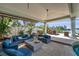 Offers an outdoor lounge area with waterfront view and a covered patio with a fire pit at 8032 13Th S Ave, St Petersburg, FL 33707
