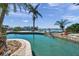 Inviting pool area with stunning waterfront views and lush landscaping, enhancing the property's appeal at 8032 13Th S Ave, St Petersburg, FL 33707