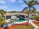 Aerial view of a backyard featuring a gorgeous pool, spa, and outdoor entertaining area at 8032 13Th S Ave, St Petersburg, FL 33707