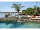 Beautiful pool and hot tub with lush landscaping and waterfront views at 8032 13Th S Ave, St Petersburg, FL 33707