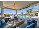 Features a covered patio with outdoor seating and a fire pit, overlooking a waterfront view and a private pool at 8032 13Th S Ave, St Petersburg, FL 33707