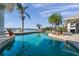 Gorgeous waterfront pool surrounded by tropical landscaping, seamlessly blending indoor and outdoor living at 8032 13Th S Ave, St Petersburg, FL 33707