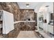 Stylish shower featuring marble walls, neutral tile flooring, and modern shower fixtures at 8032 13Th S Ave, St Petersburg, FL 33707