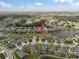 An aerial shot of a residential neighborhood, showing homes nestled among lakes and trees at 8141 Carlton Ridge Dr, Land O Lakes, FL 34638