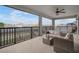 Outdoor balcony with stylish seating and a ceiling fan, perfect for enjoying the view and outdoor living at 8141 Carlton Ridge Dr, Land O Lakes, FL 34638
