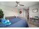 Well-lit bedroom with patterned wallpaper, and ceiling fan providing a comfortable and stylish space at 8141 Carlton Ridge Dr, Land O Lakes, FL 34638