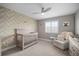Serene bedroom with a crib, natural light and calming decor creating a peaceful environment at 8141 Carlton Ridge Dr, Land O Lakes, FL 34638