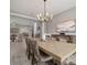 Spacious dining room featuring a long table, chandelier, and decorative buffet with views to the living room at 8141 Carlton Ridge Dr, Land O Lakes, FL 34638