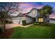 Charming two-story home features a two-car garage and a well-manicured lawn and landscaping at 8141 Carlton Ridge Dr, Land O Lakes, FL 34638