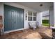 Inviting front porch features double doors, brick pavers, and comfortable seating at 8141 Carlton Ridge Dr, Land O Lakes, FL 34638