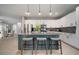 Modern kitchen island featuring seating and pendant lighting with an open-concept design at 8141 Carlton Ridge Dr, Land O Lakes, FL 34638