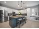 Modern kitchen featuring a large island, stainless steel appliances, pendant lighting, and white cabinetry at 8141 Carlton Ridge Dr, Land O Lakes, FL 34638