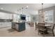 Open concept living area showcasing the kitchen, living room with fireplace, and dining area with modern lighting at 8141 Carlton Ridge Dr, Land O Lakes, FL 34638