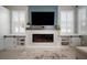 Bright living room boasts a fireplace, built-in shelving, and large windows with classic white shutters at 8141 Carlton Ridge Dr, Land O Lakes, FL 34638