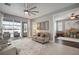 Bright living room with a large window and sliding glass doors providing seamless indoor-outdoor living at 8141 Carlton Ridge Dr, Land O Lakes, FL 34638