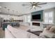 Bright, open-concept living area with modern kitchen, fireplace, comfortable seating, and stylish decor at 8141 Carlton Ridge Dr, Land O Lakes, FL 34638