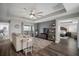 Bright living room featuring dark hardwood floors, plush sofa, and balcony access at 8141 Carlton Ridge Dr, Land O Lakes, FL 34638